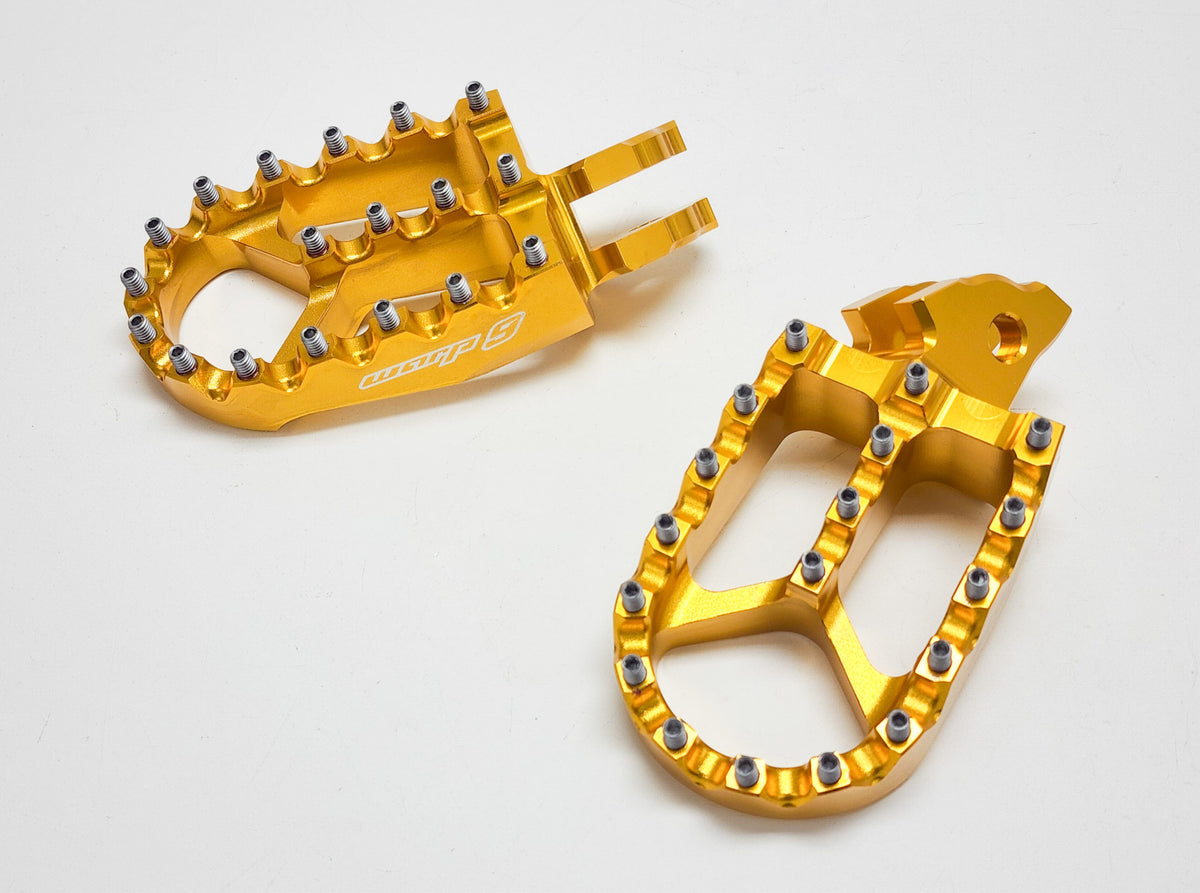 Modded Moto Co Warp 9 Talaria and Sigma foot pegs installed on motorcycle, close-up view of sturdy metal foot pegs for biking.