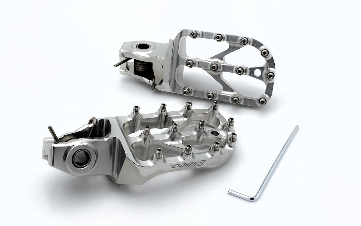 Modded Moto Co Warp 9 Stark Varg Elite foot pegs mounted on motorcycle, showcasing durable metal construction and sleek design.