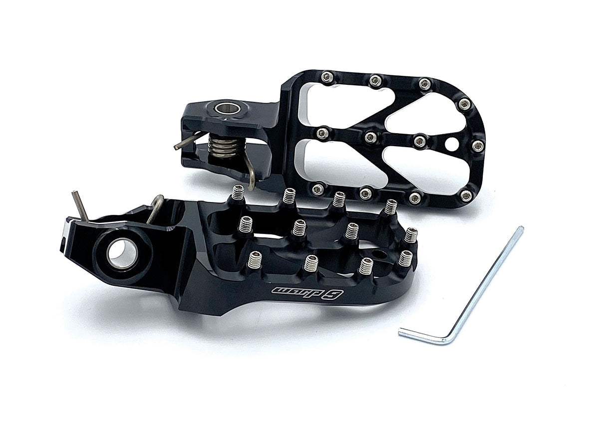 Modded Moto Co Warp 9 Stark Varg Elite foot pegs installed on motorcycle, showing durable metal construction and secure mounting.