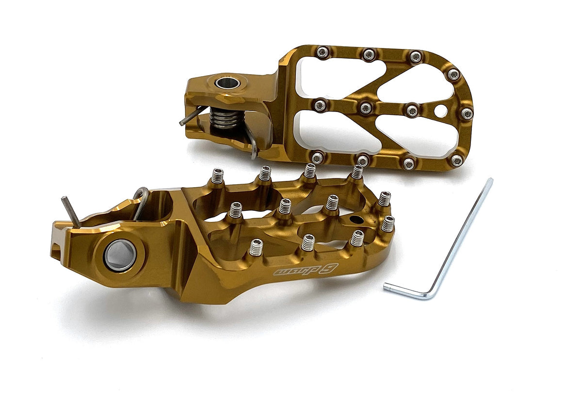 Modded Moto Co Warp 9 Stark Varg Elite foot pegs for motorcycle, durable metal construction with textured grip surfaces.