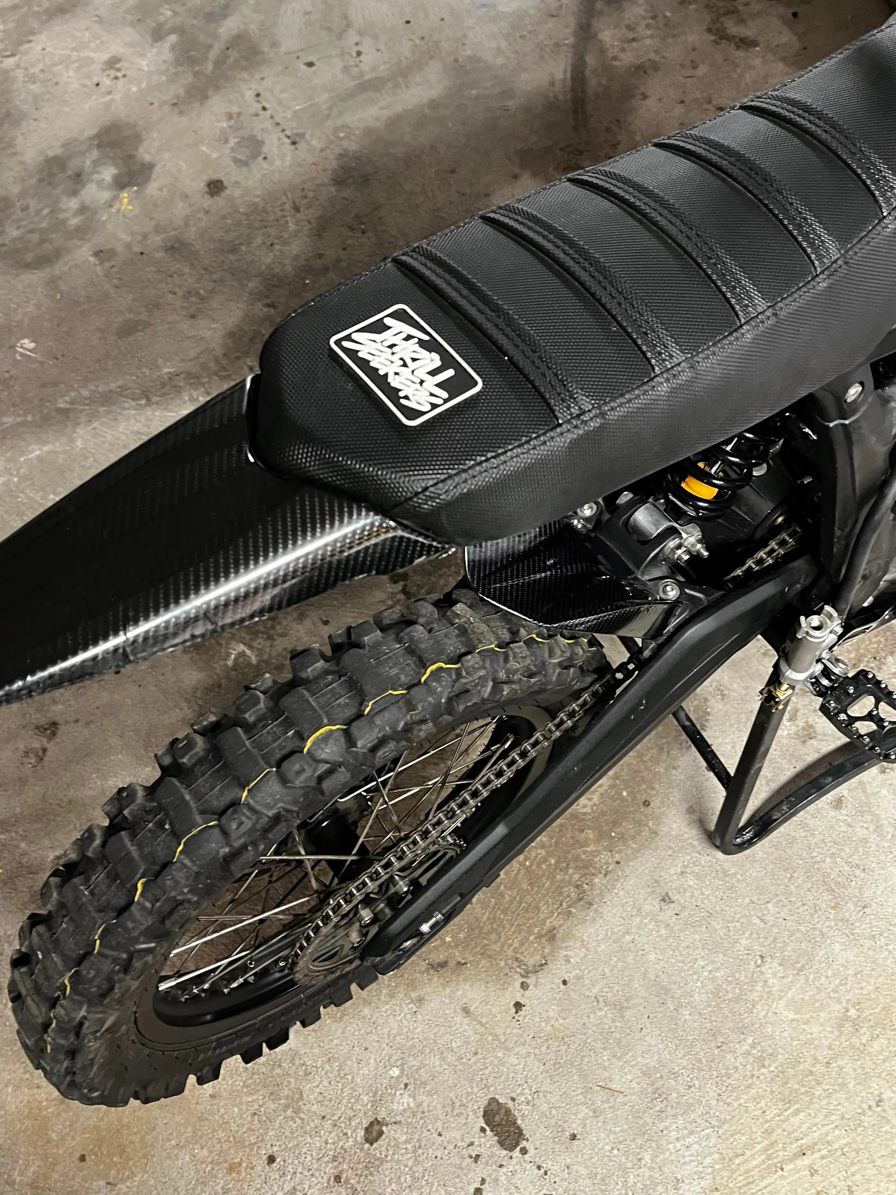 MXwraps Talaria Mx3/Mx4 carbon fiber vinyl wrap kit with black and gray textured finish on a car surface.