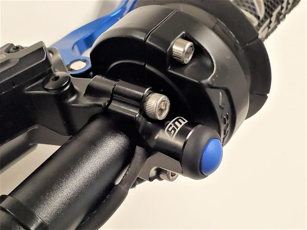 Warp 9 Surron Light Button for cockpit controls by Modded Moto Co, shown in close-up image.