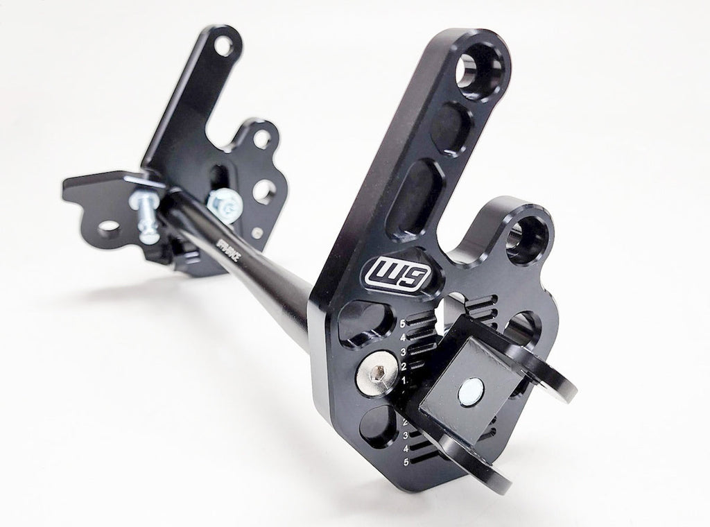 Modded Moto Co Warp 9 Talaria adjustable foot peg mount for motorcycle foot pegs, showing metal bracket and mounting hardware.