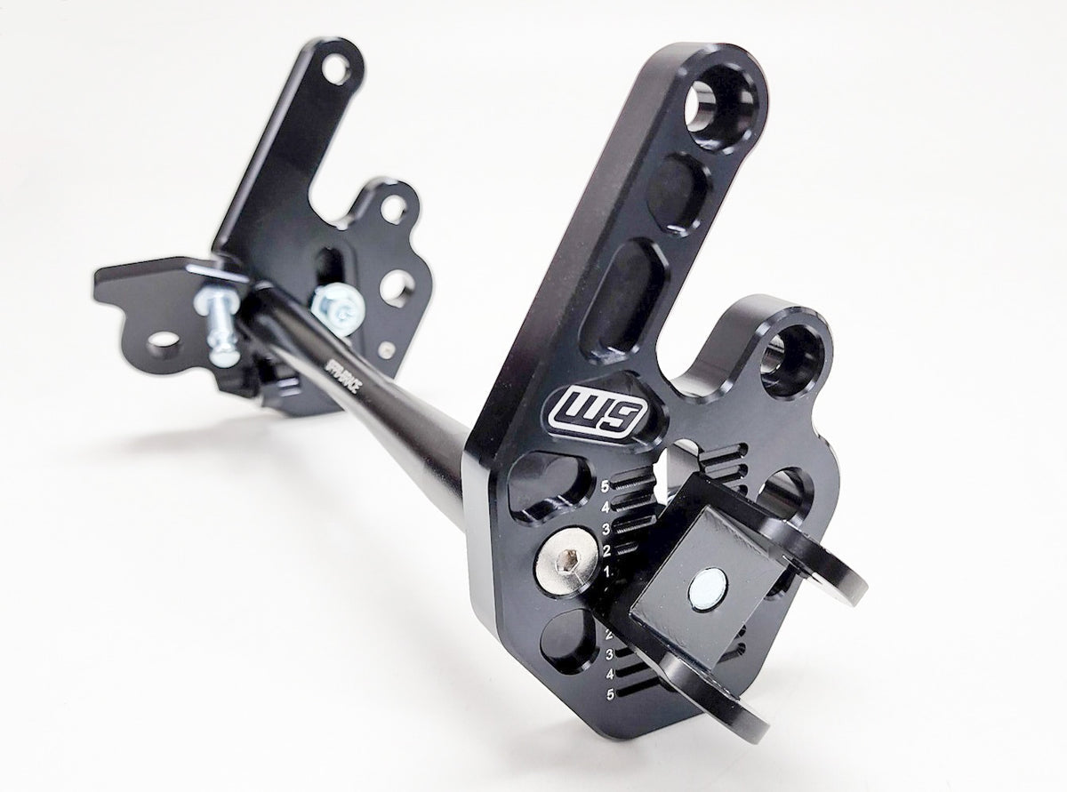 Modded Moto Co Warp 9 Talaria adjustable foot peg mount for motorcycle foot pegs, showing metal bracket and mounting hardware.