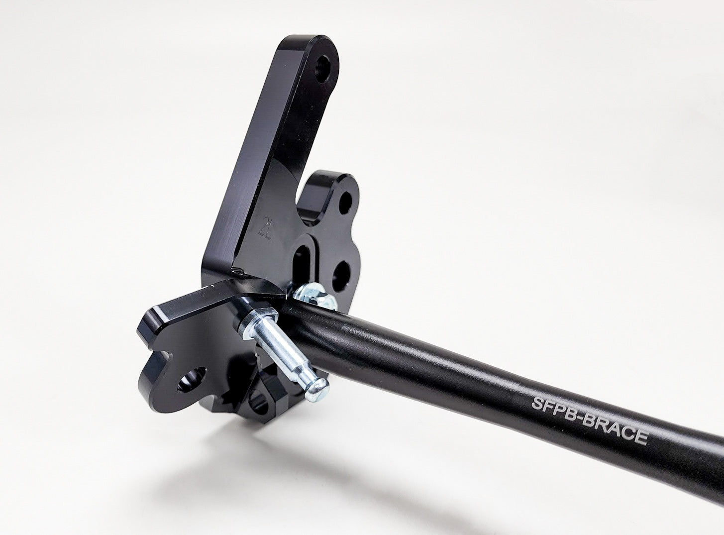 Modded Moto Co Warp 9 Talaria adjustable foot peg mount for motorcycle, showing the sturdy metal construction and mounting mechanism.