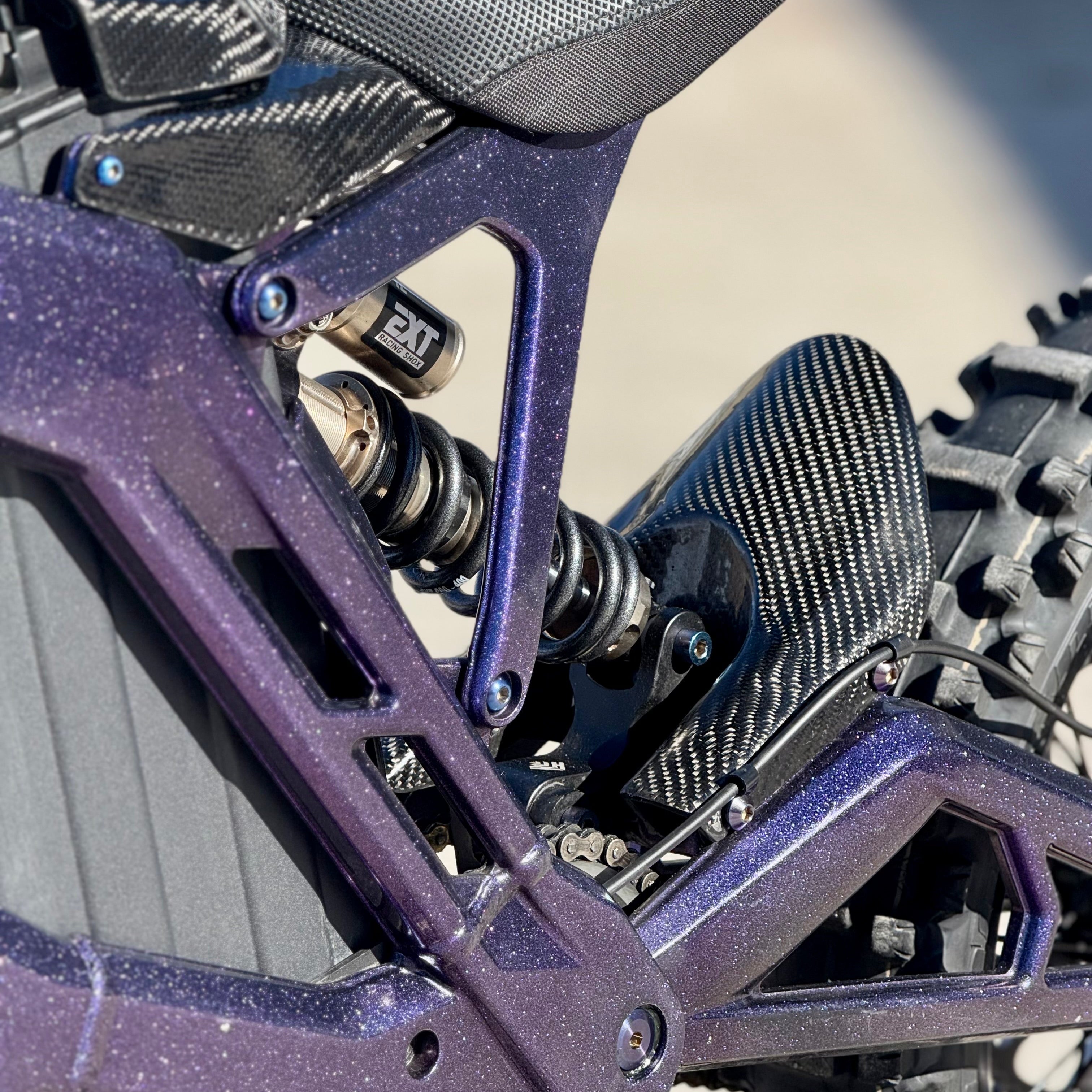 Modded Moto Co E-Ride Pro carbon fiber mud guard for e-bike, lightweight body protection with sleek carbon fiber finish.