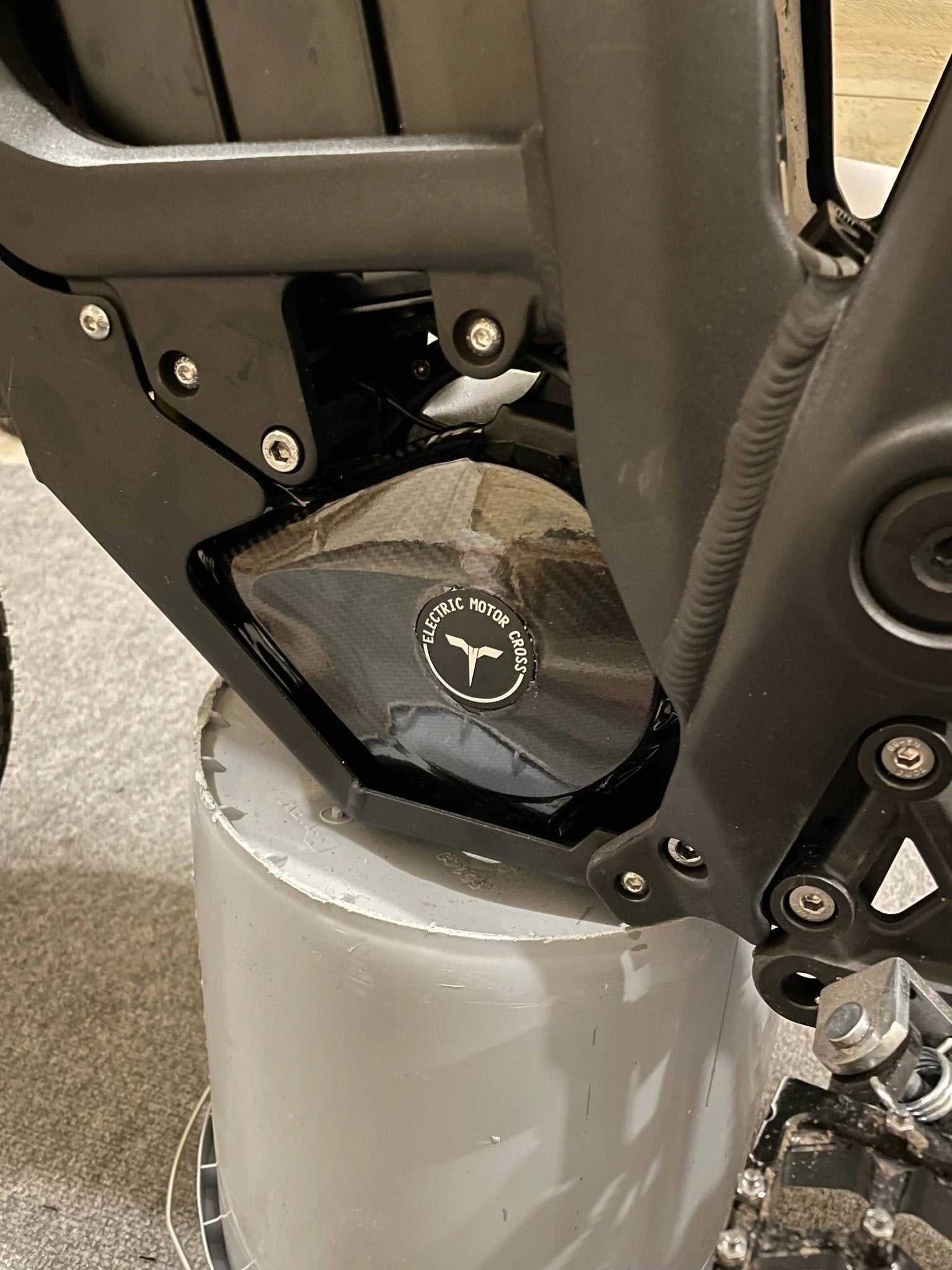 Black carbon fiber vinyl wrap kit for Talaria MX3 and MX4 electric bikes, featuring textured carbon fiber finish from MXwraps.