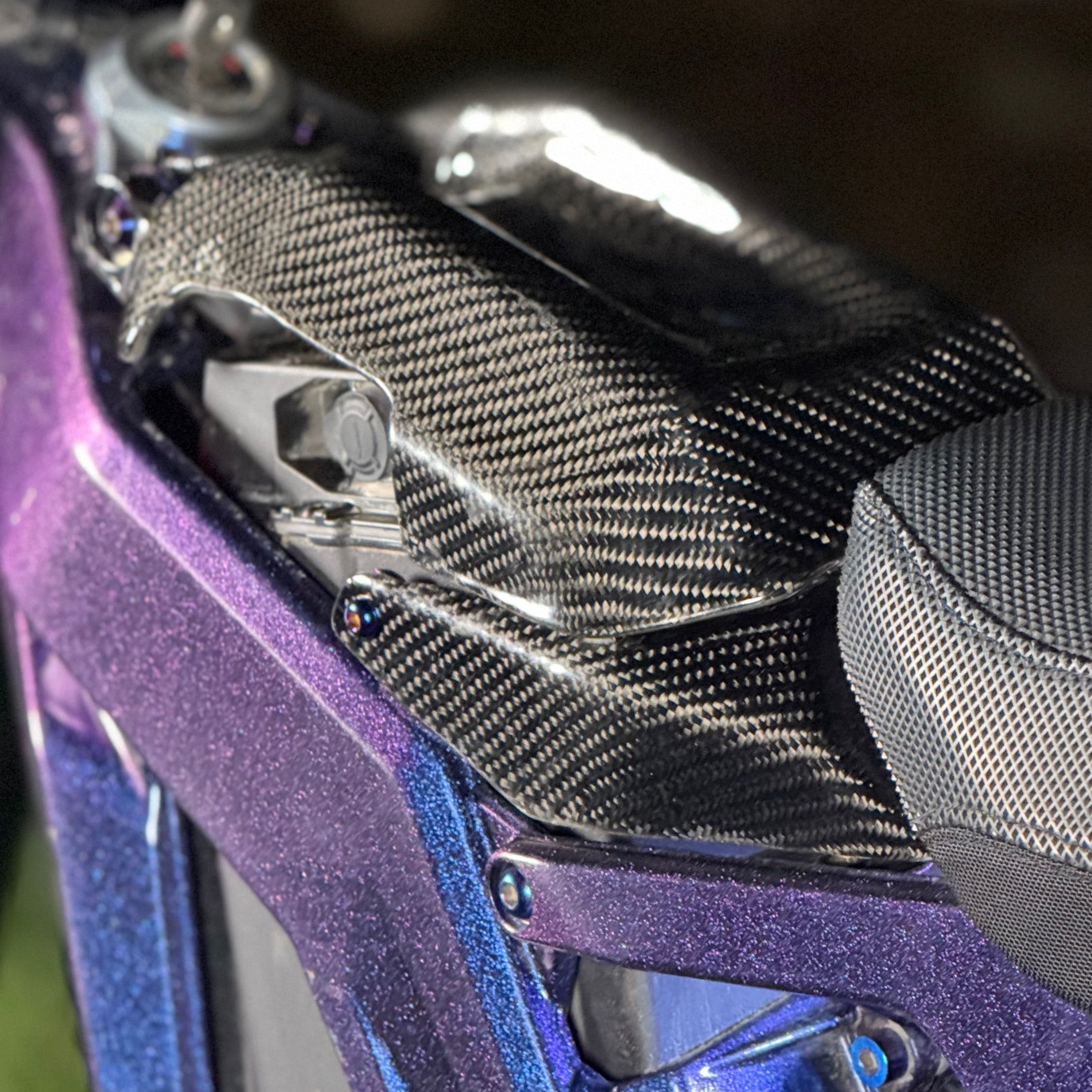 Modded Moto Co E-Ride Pro carbon fiber battery lid lock for e-bike, showcasing sleek black design and secure lock mechanism.