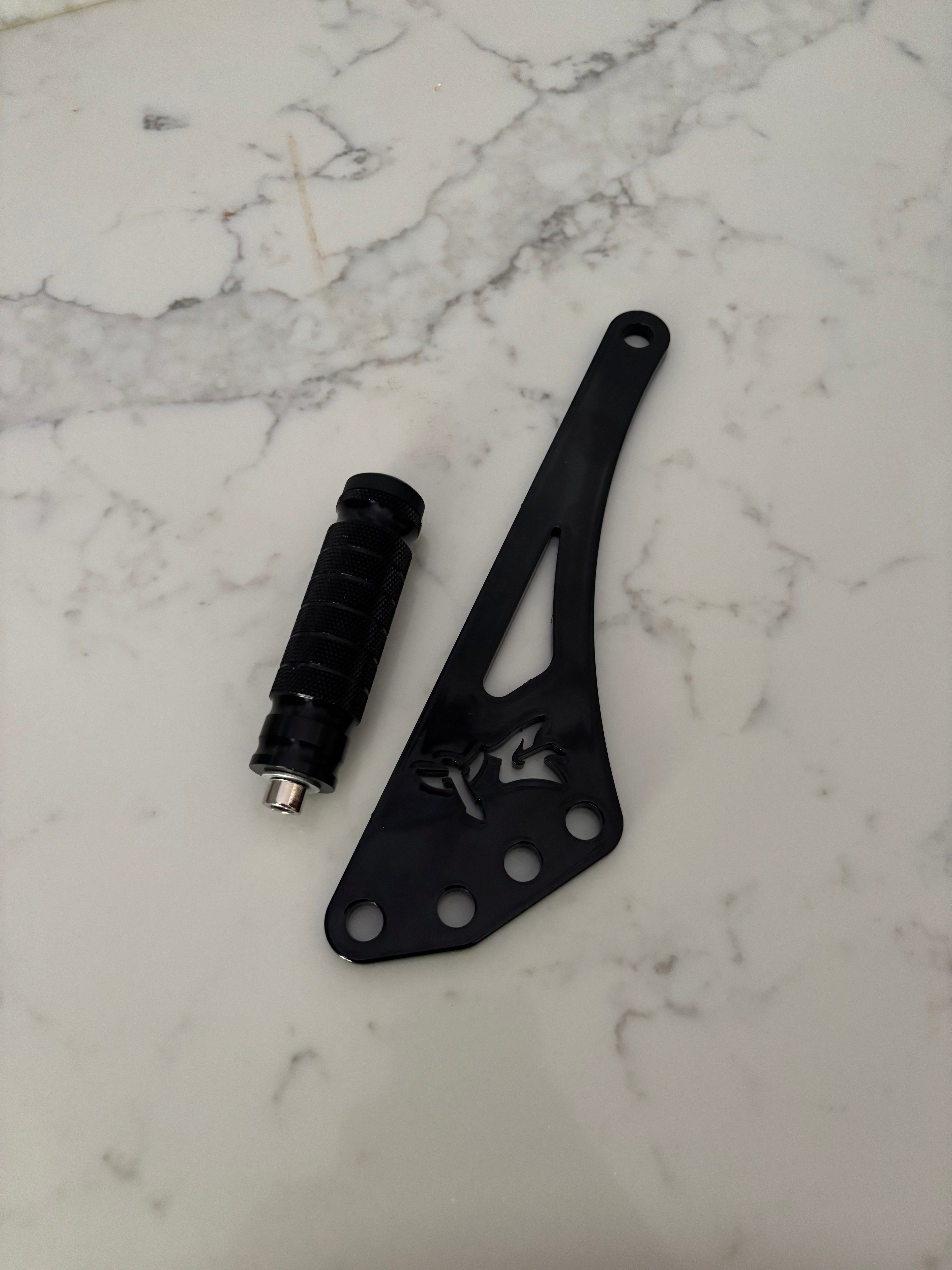 Eride Pro Shiftlock by TG Racing, a durable gear shifter lock with a sleek black finish and robust construction.