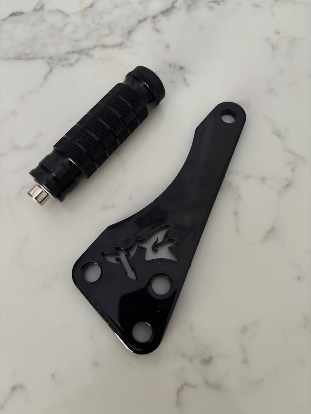 TG Racing Talaria X3 footlock and bracket, metal racing bike components, mounted on a bicycle frame, for secure pedal attachment.