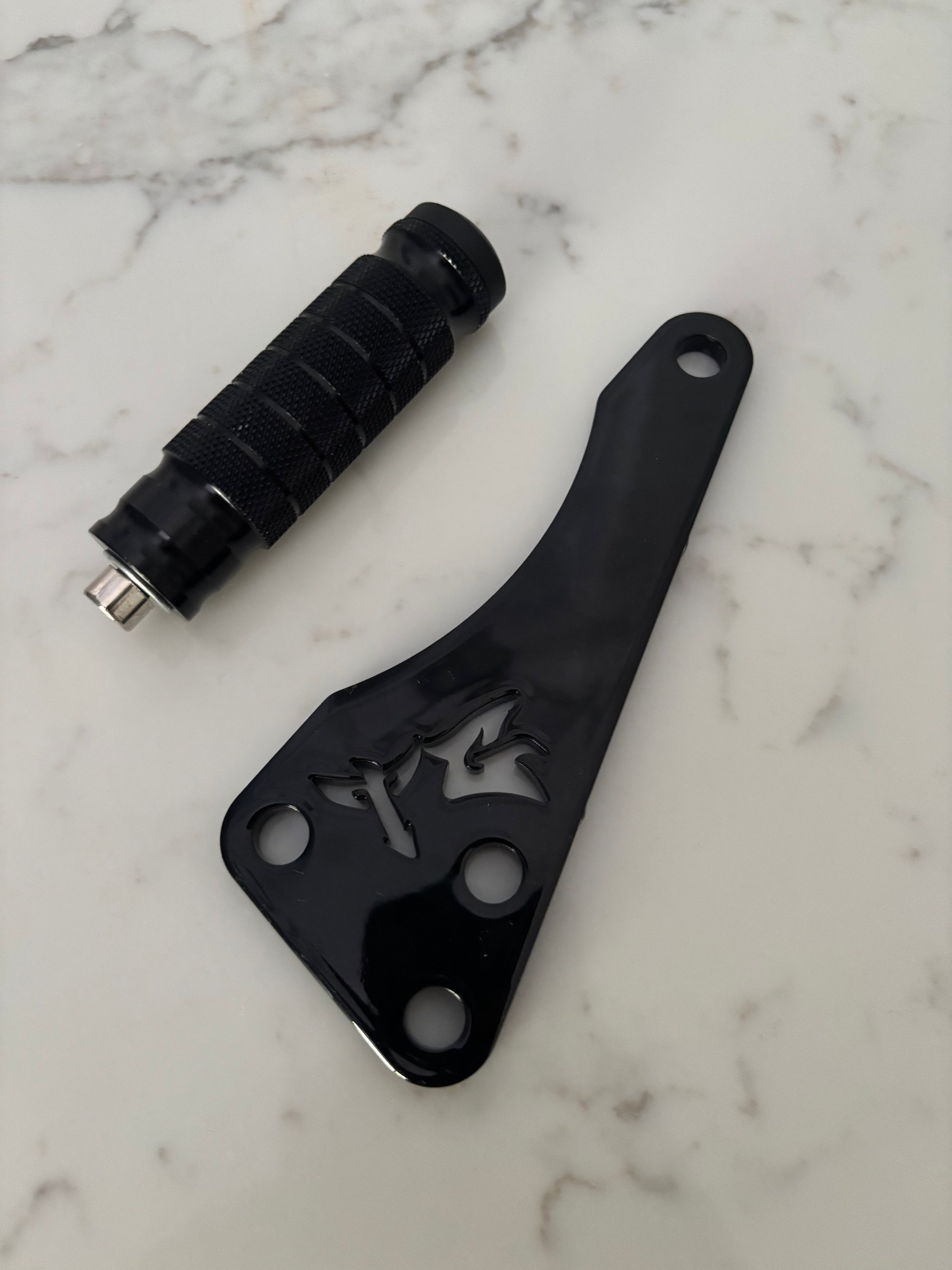 TG Racing Talaria X3 footlock and bracket, metal racing bike components, mounted on a bicycle frame, for secure pedal attachment.
