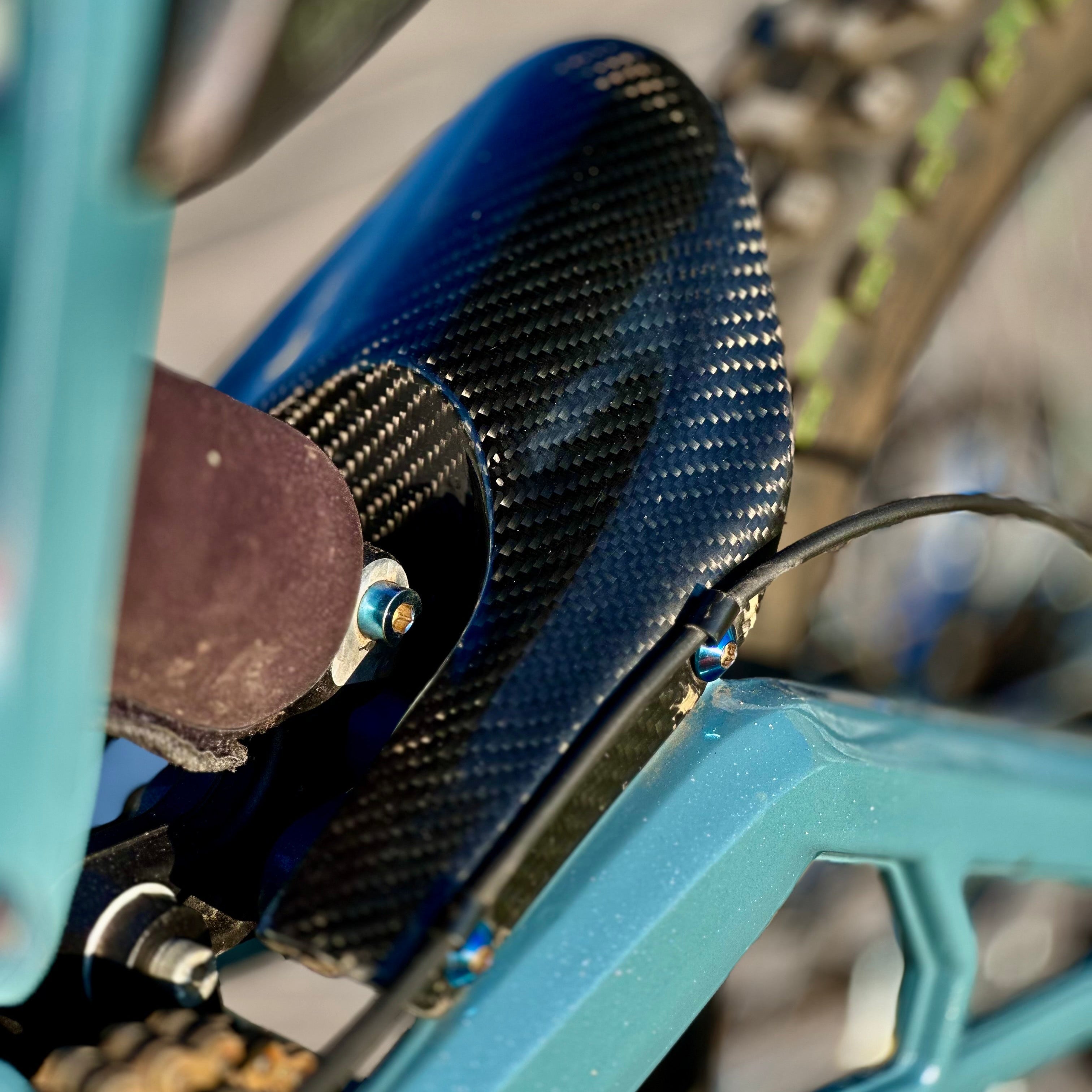 Modded Moto Co E-Ride Pro carbon fiber mud guard for e-bike, lightweight body protection, shown mounted on bike.