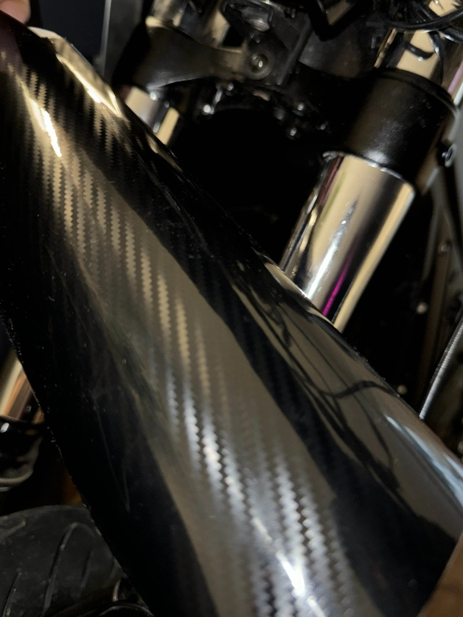 MXwraps E-bike fork wrap kit in black vinyl, showcasing a sleek, custom-designed protective wrap installed on a bicycle fork.