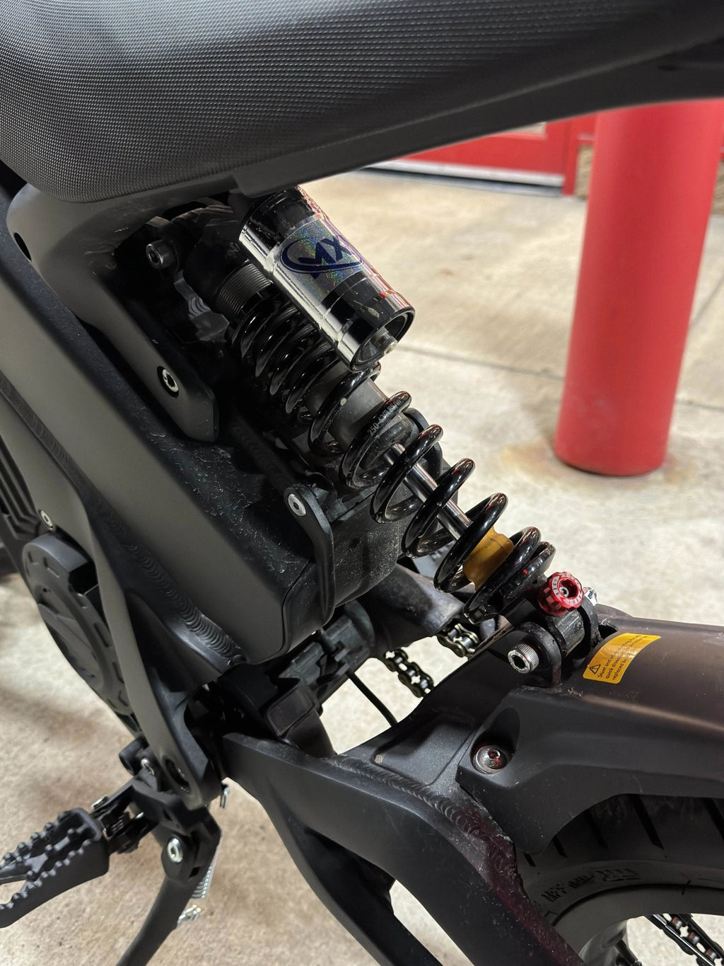 MXwraps E-bike fork vinyl wrap kit showing black and white design applied to fork with detailed close-up.