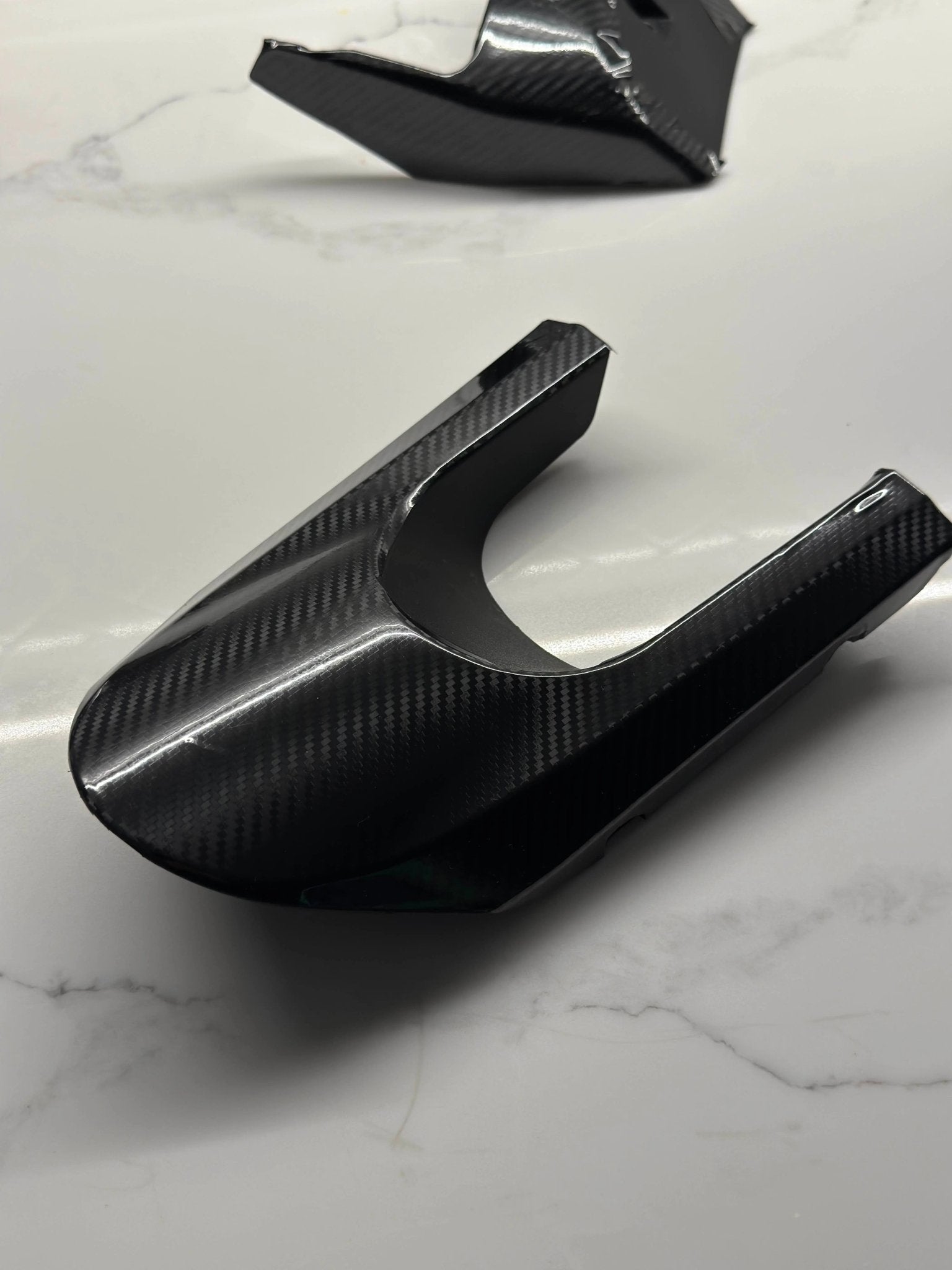 MXwraps E Ride Pro carbon fiber vinyl wrap kit showing textured black carbon fiber finish on a vehicle part.
