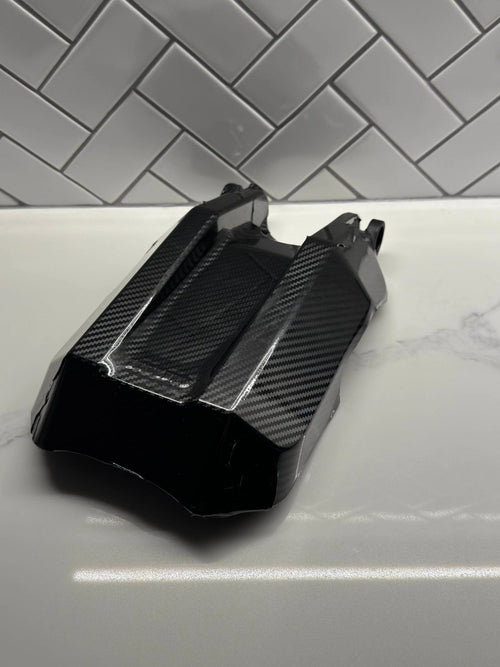 MXwraps E Ride Pro carbon fiber vinyl wrap kit shown on a vehicle, featuring a sleek, textured carbon fiber finish for custom automotive styling.