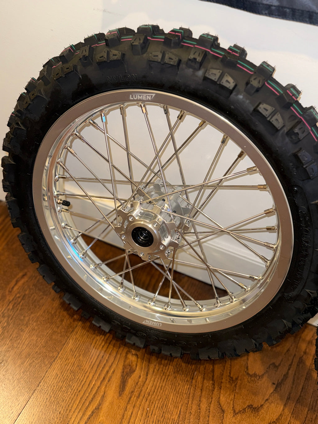 Lumen Racing 16/19 Light Bee/Eride Pro wheelset with preinstalled dirt tires, showcasing lightweight aluminum rims and rugged tread.