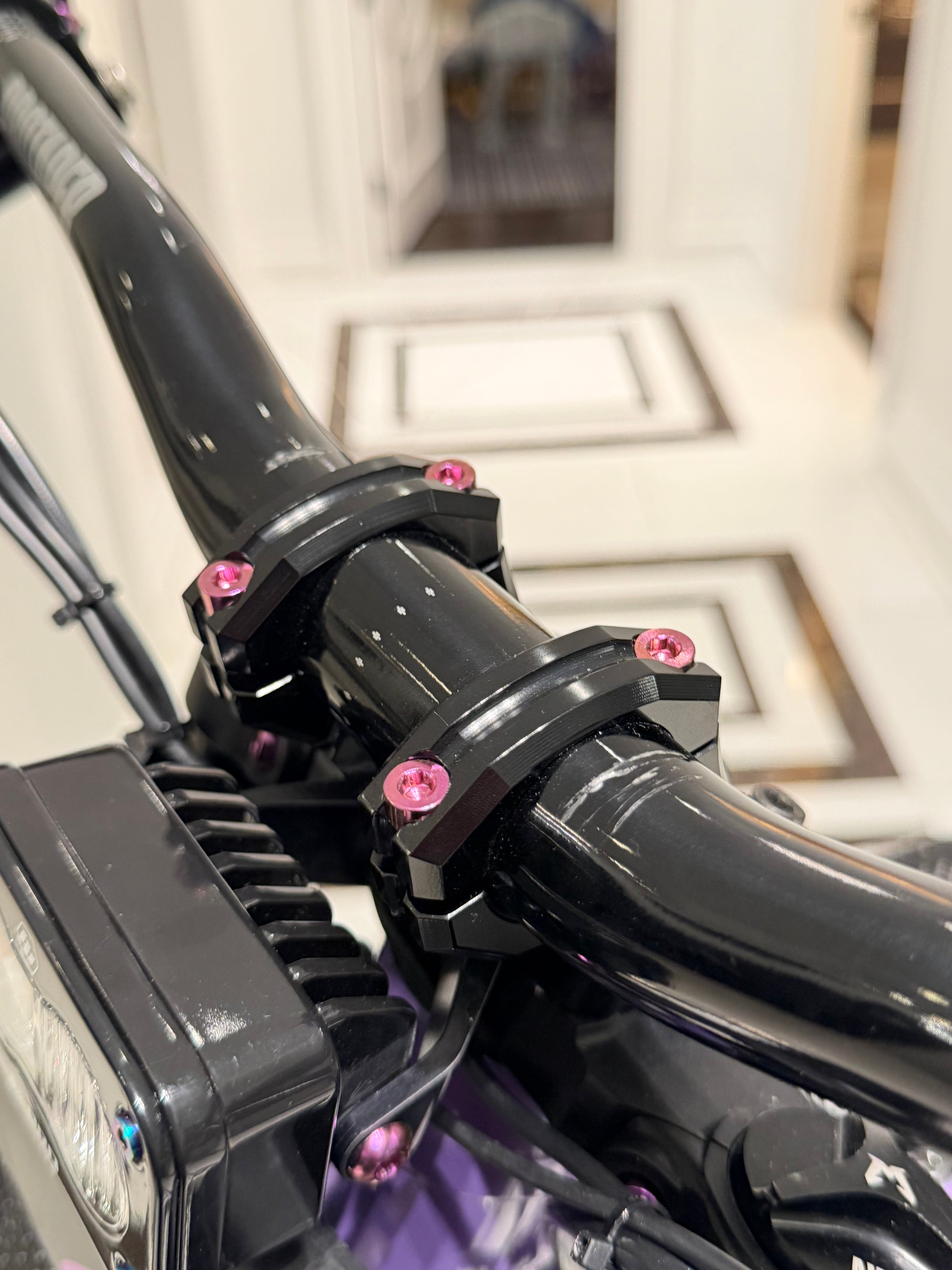 Set of four DevMoto Deity & DevMoto direct mount titanium bolts for bicycle components, shown in a close-up image.