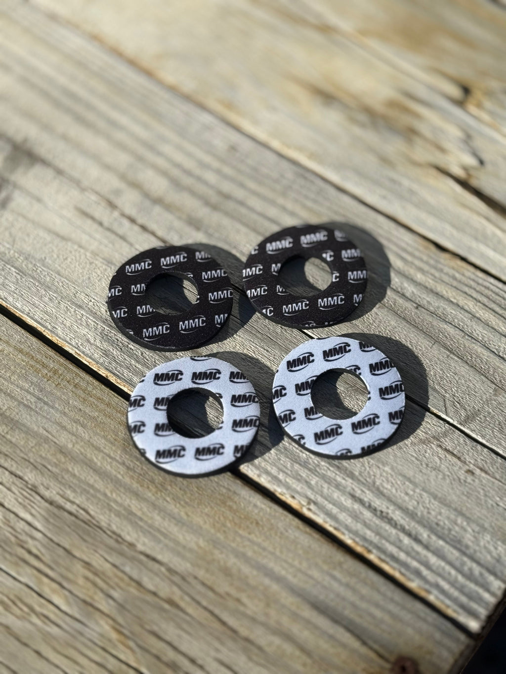 Modded Moto Co MMC Grip Donuts accessory with black rubber grips and metal accents, designed for motorcycle handlebars.