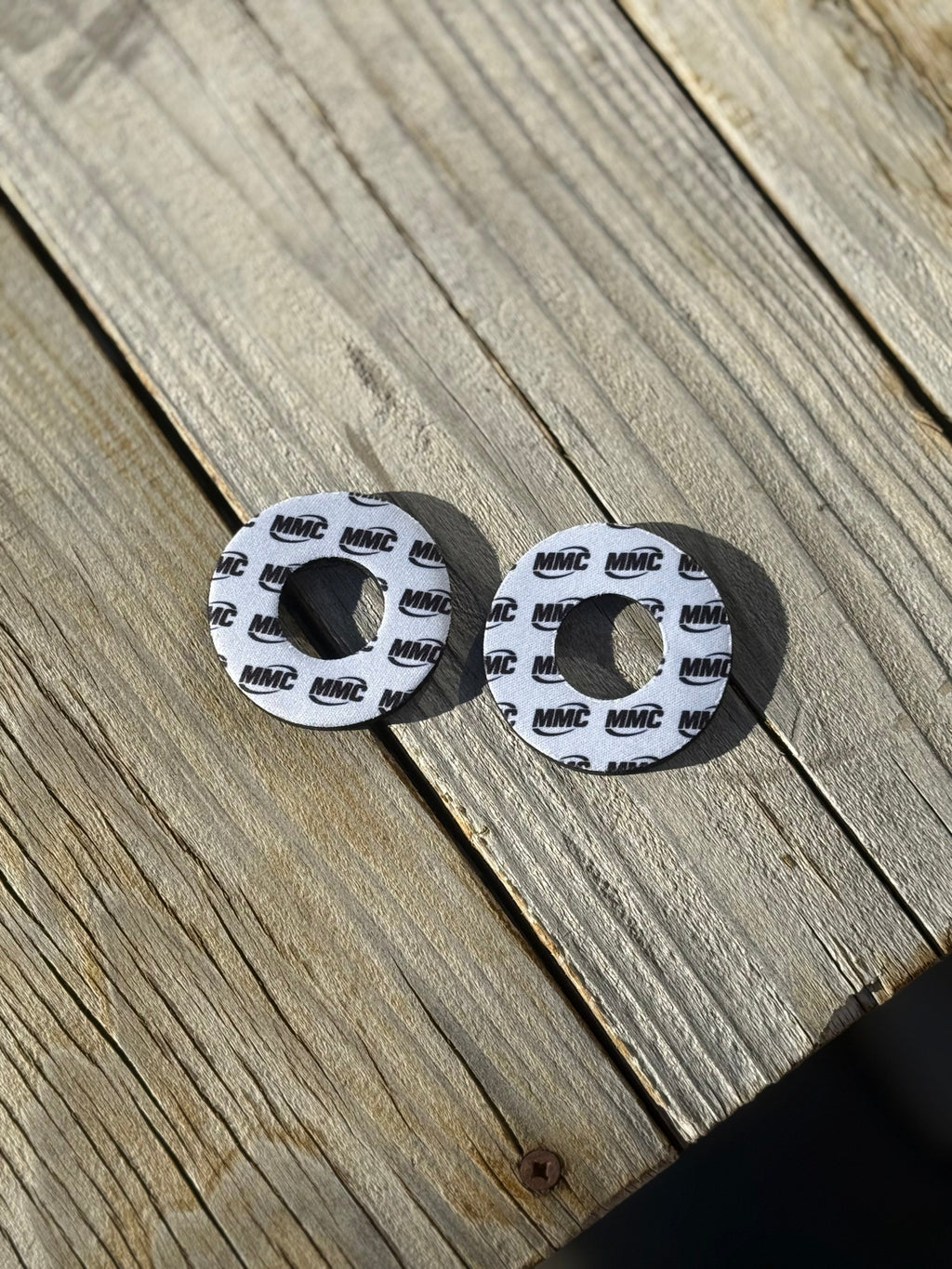 Modded Moto Co MMC Grip Donuts accessory with black rubber grip donuts on a motorcycle handlebar for improved grip.