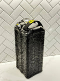 Front corner view of MXwraps ShadowSlate black camouflage vinyl wrap on e-bike battery, showcasing sleek camouflage design.