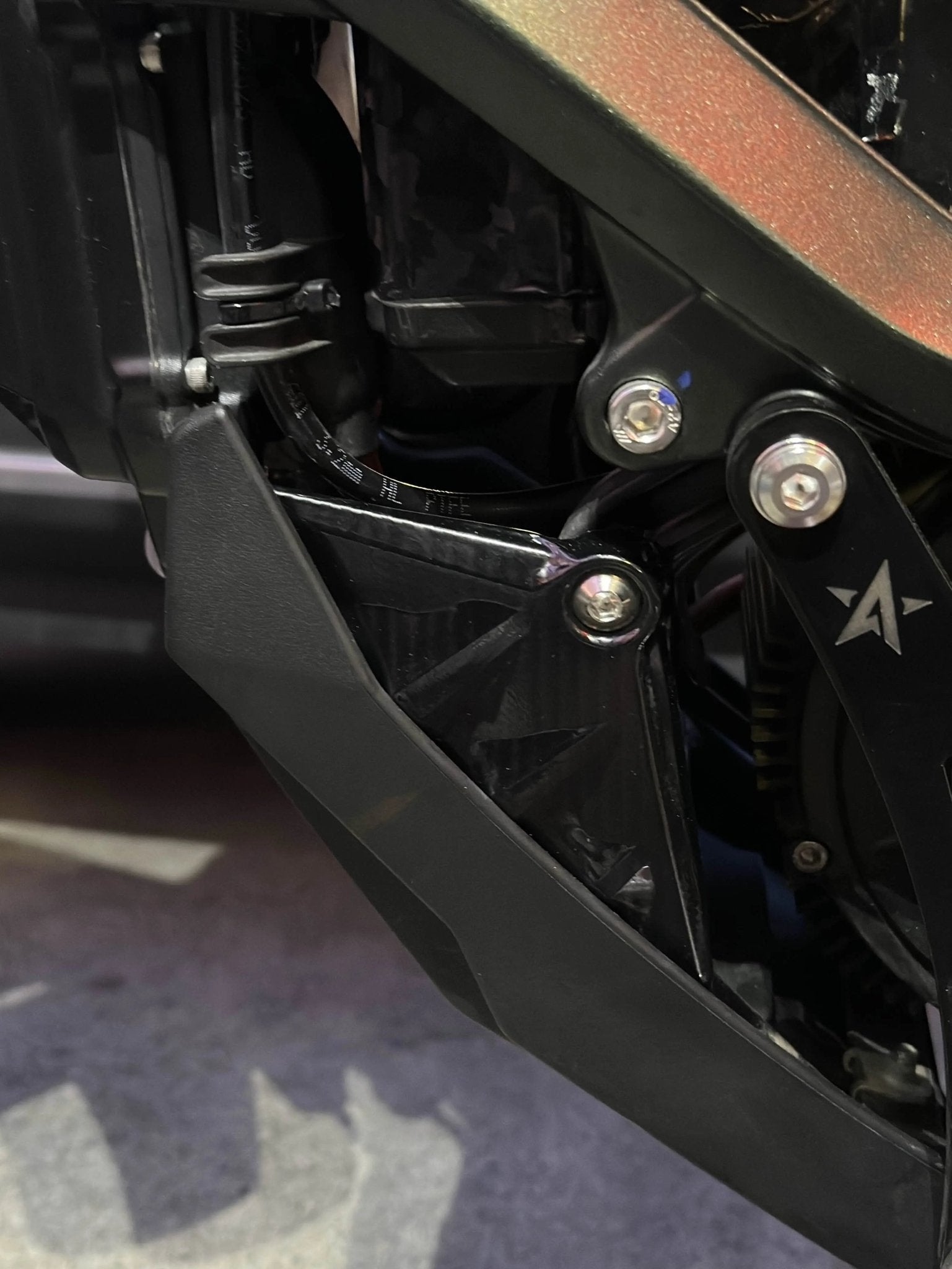 MXwraps Surron Ultra Bee carbon fiber vinyl wrap kit with bash guards, showcasing sleek, durable protective film on electric bike parts.