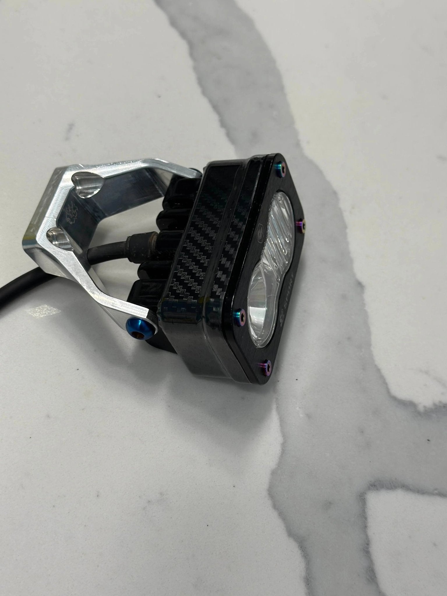 Carbon fiber Baja Style Headlight Wrap by MXwraps, a durable vinyl wrap designed for off-road vehicle headlights.