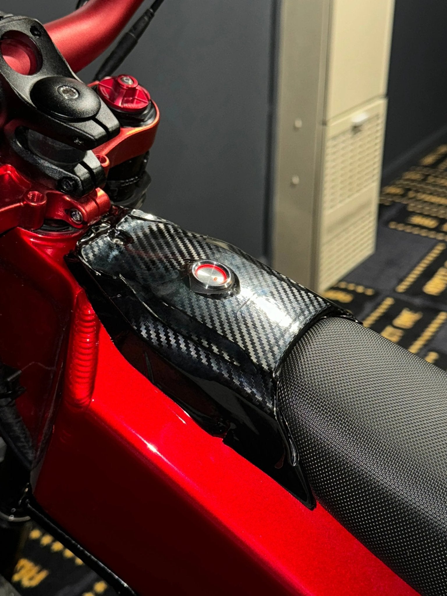 MXwraps Talaria XXX carbon fiber vinyl wrap kit showing textured black and gray patterned design for vehicle customization.