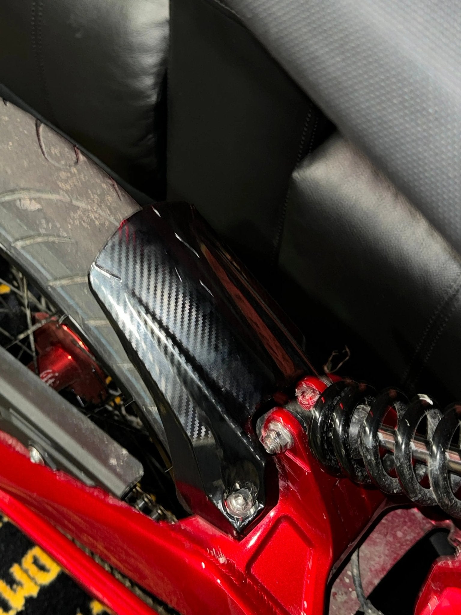 MXwraps Talaria XXX carbon fiber vinyl wrap kit showing textured black carbon fiber finish on a vehicle surface