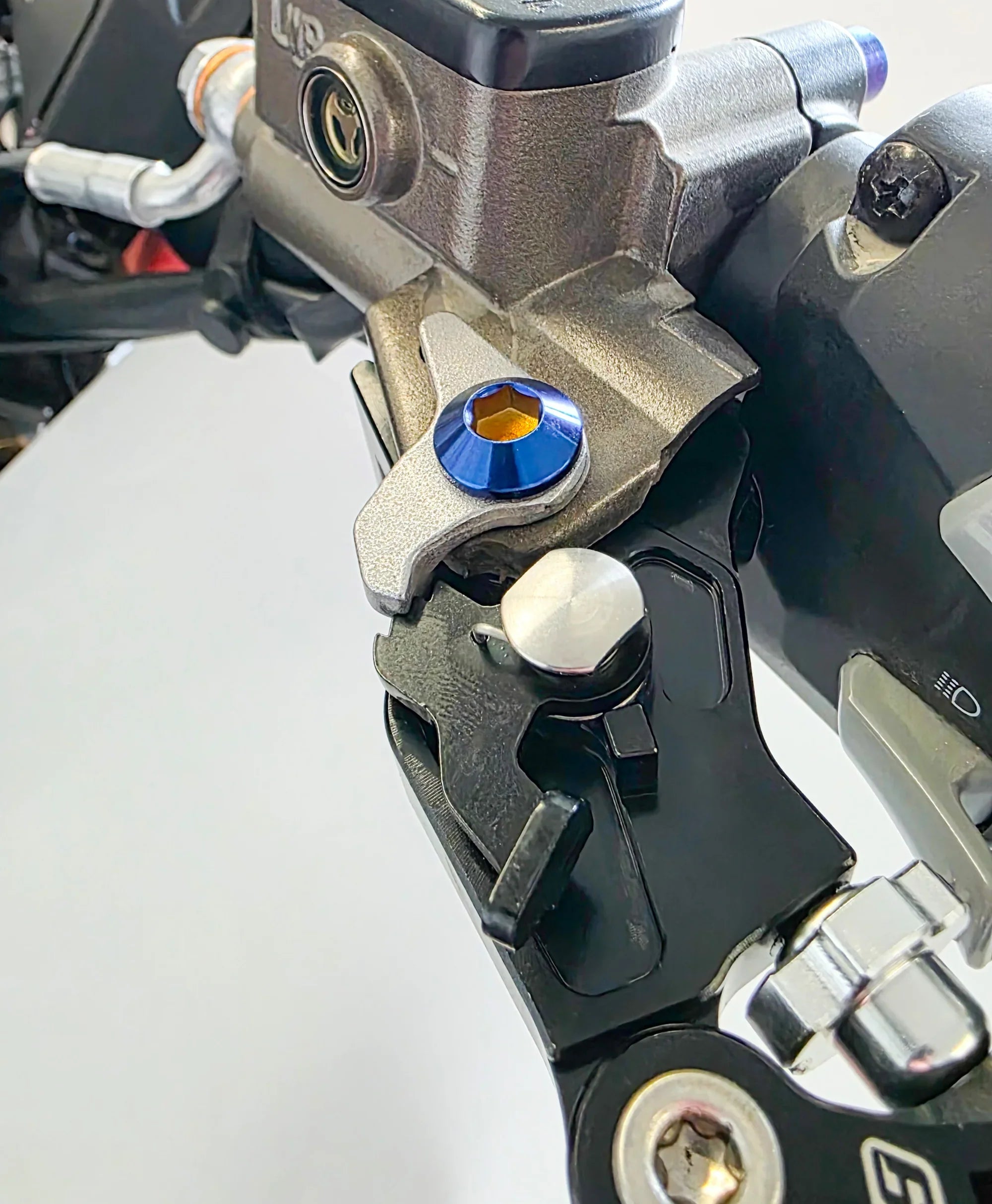 Titanium shorty style Ultra Bee lever pivot bolts by Modded Moto Co, featuring a sleek, durable design for motorcycle brake levers.