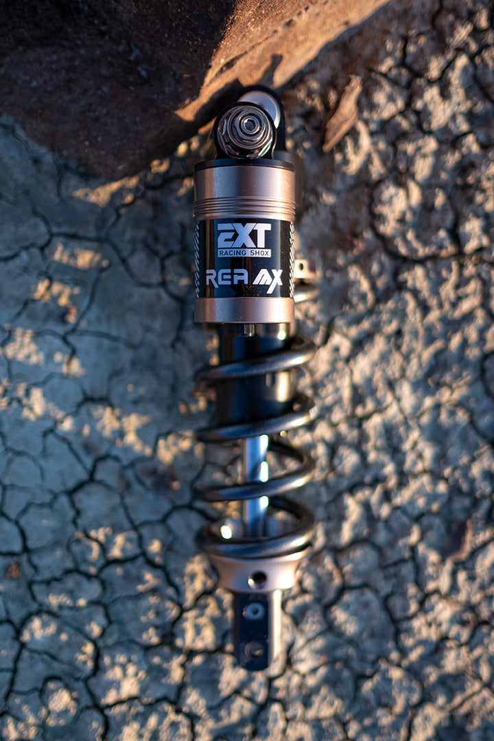Modded Moto Co EXT REA MX Shock Ultra Bee shown in a detailed side view, highlighting its durable shock absorber design.