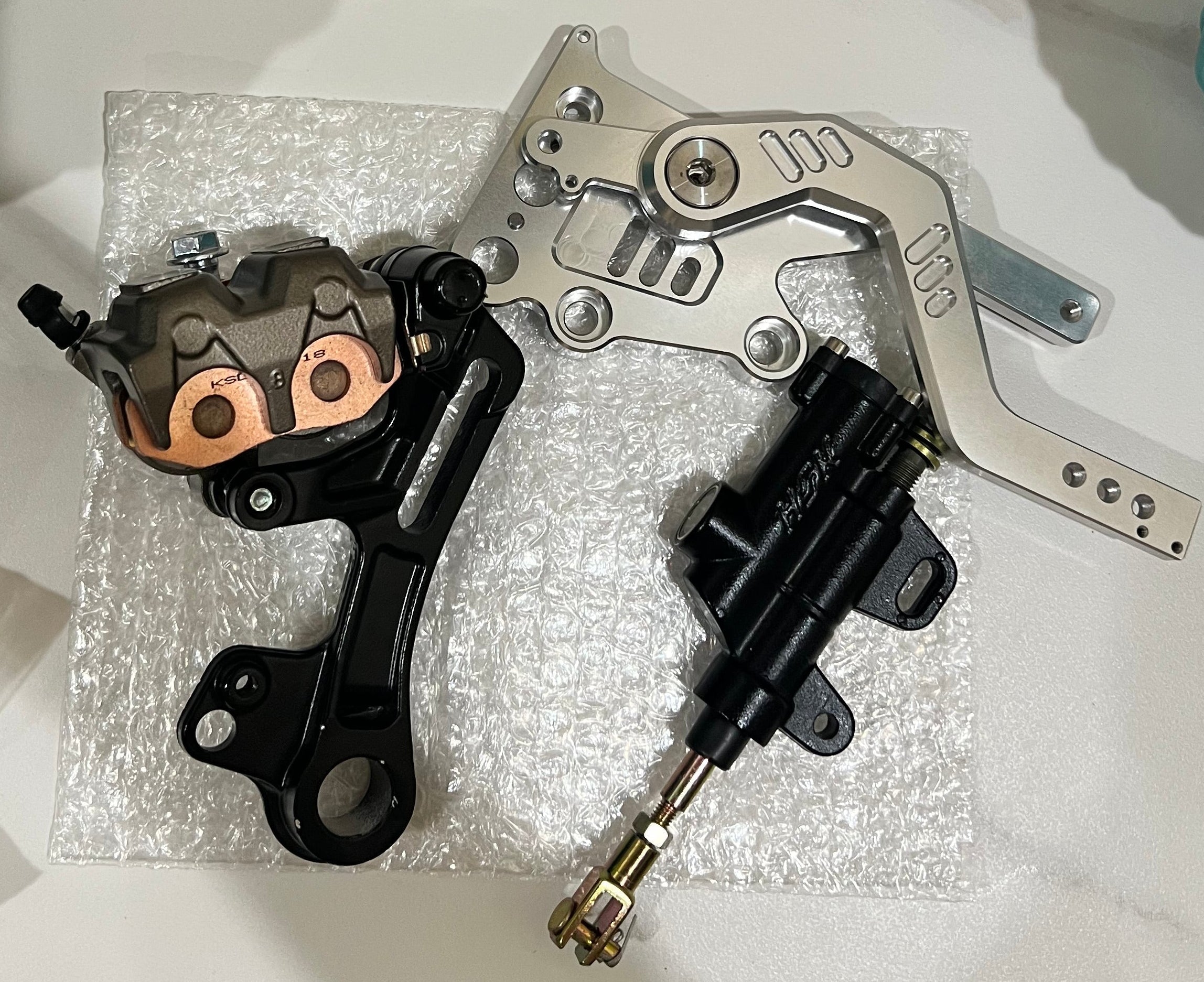 Emoto Flux Ultrasilverback Surron Light Bee/Eride pro moto foot brake kit installed on the motorcycle.